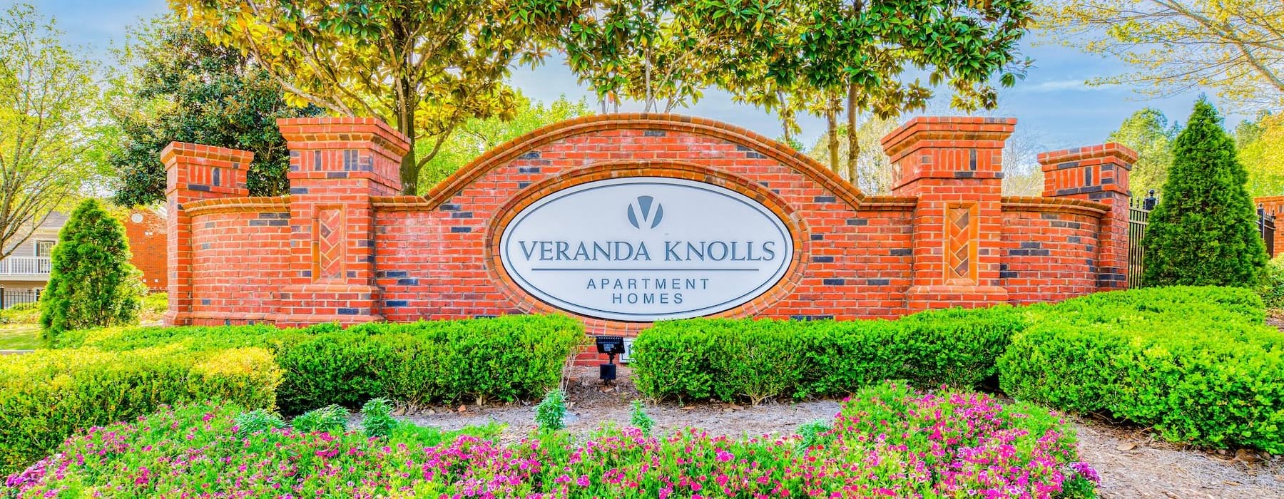 a large brick building with a sign in front of it