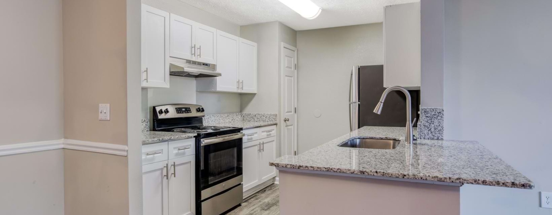 a kitchen with white cabinets