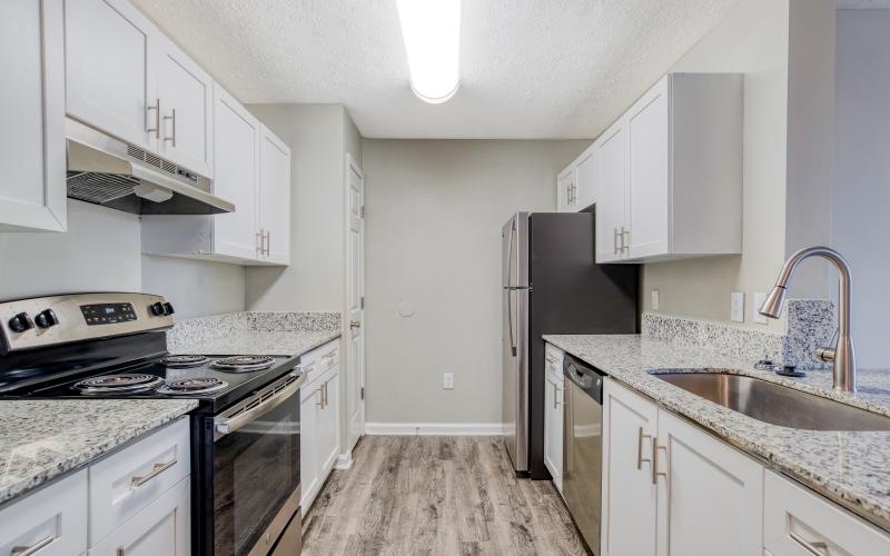 a kitchen with white cabinets
