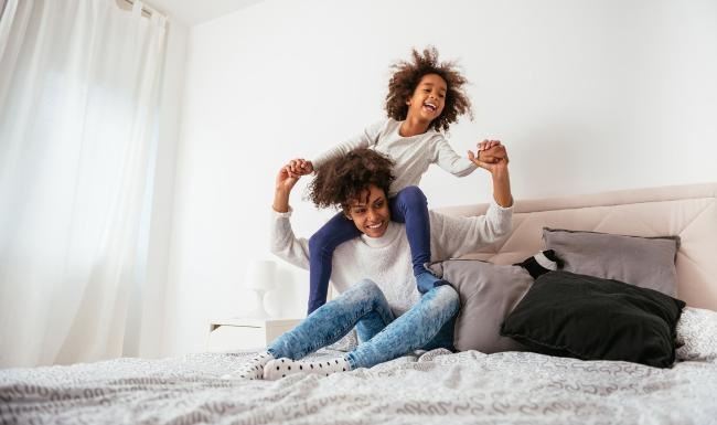 Relax and recharge in beautiful and spacious bedrooms mother and daughter happily play on a large bed